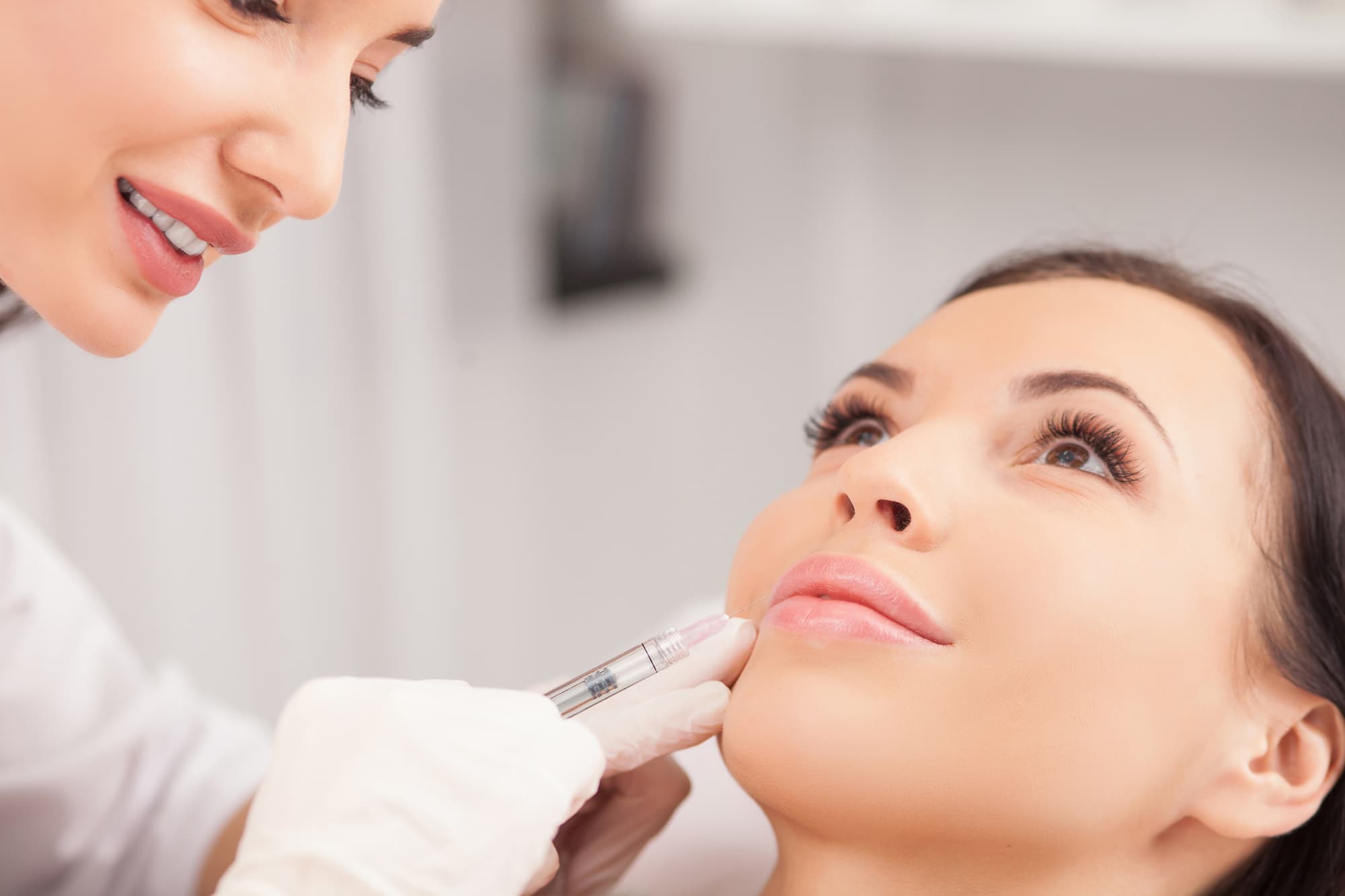 woman getting lip injection for her smile lines treatment