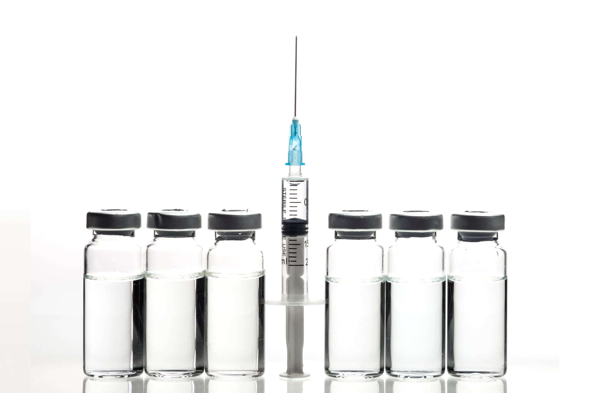 empty medical bottles and a syringe