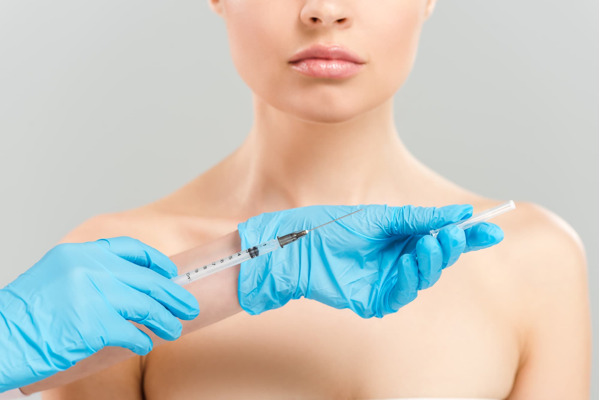 doctor with a syringe in front a of a female patient