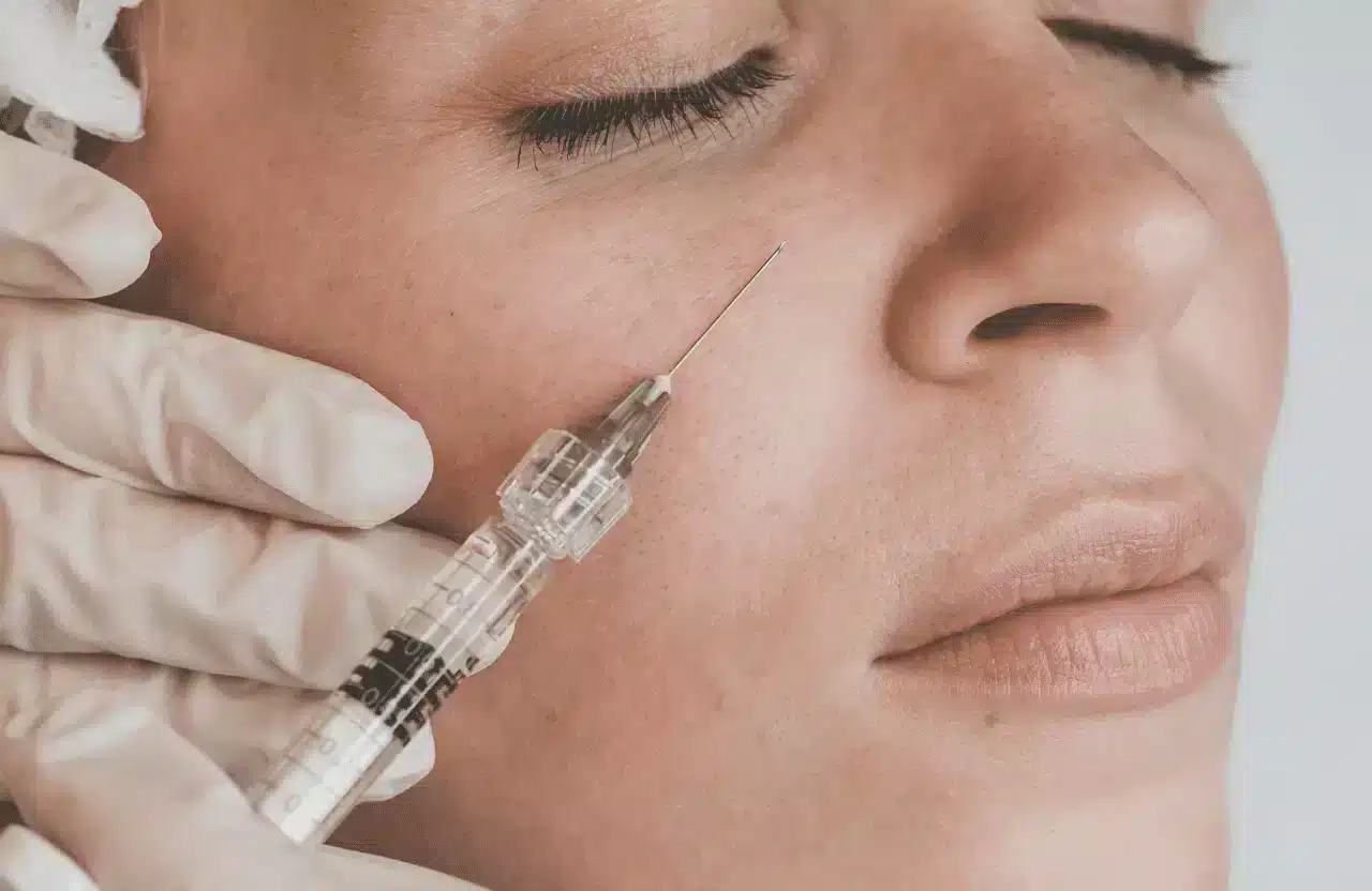 woman getting a facial filler treatment from a doctor