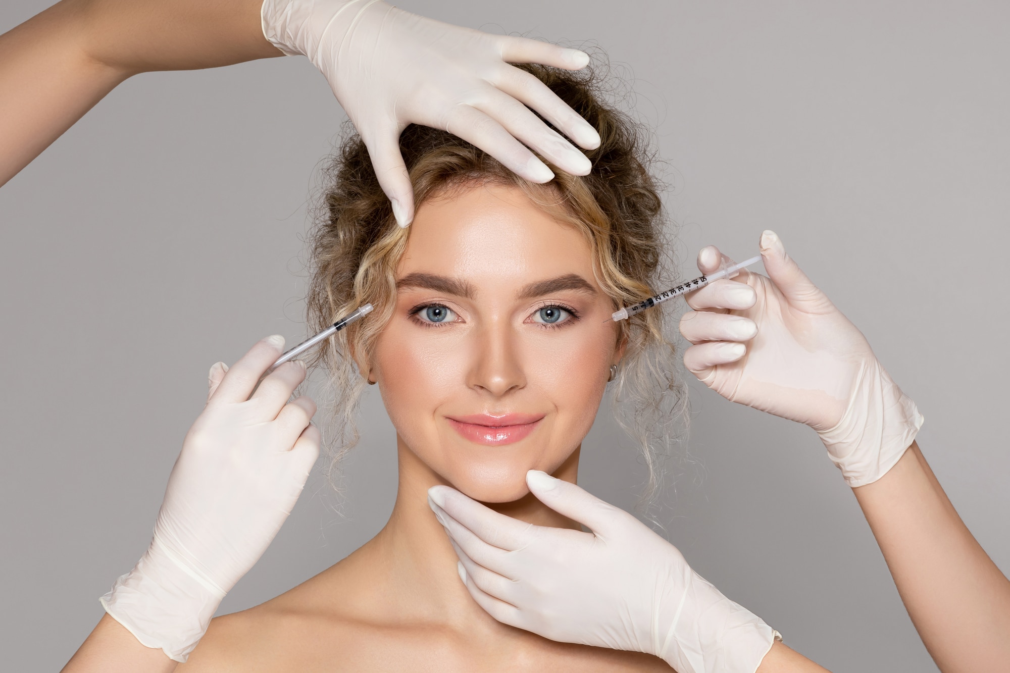 woman smiling while getting several cosmetic procedures