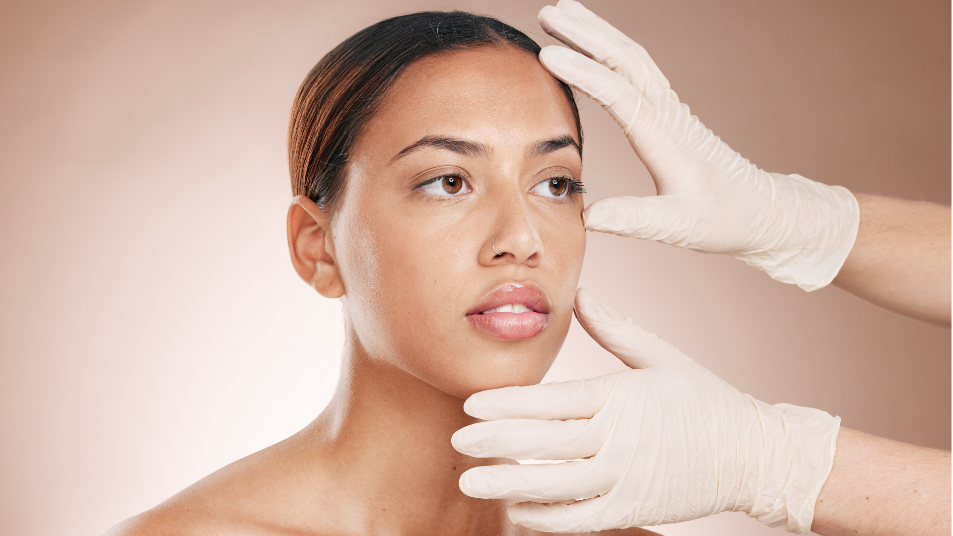 A medical professional studying the skin condition and facial anatomy of the patient.