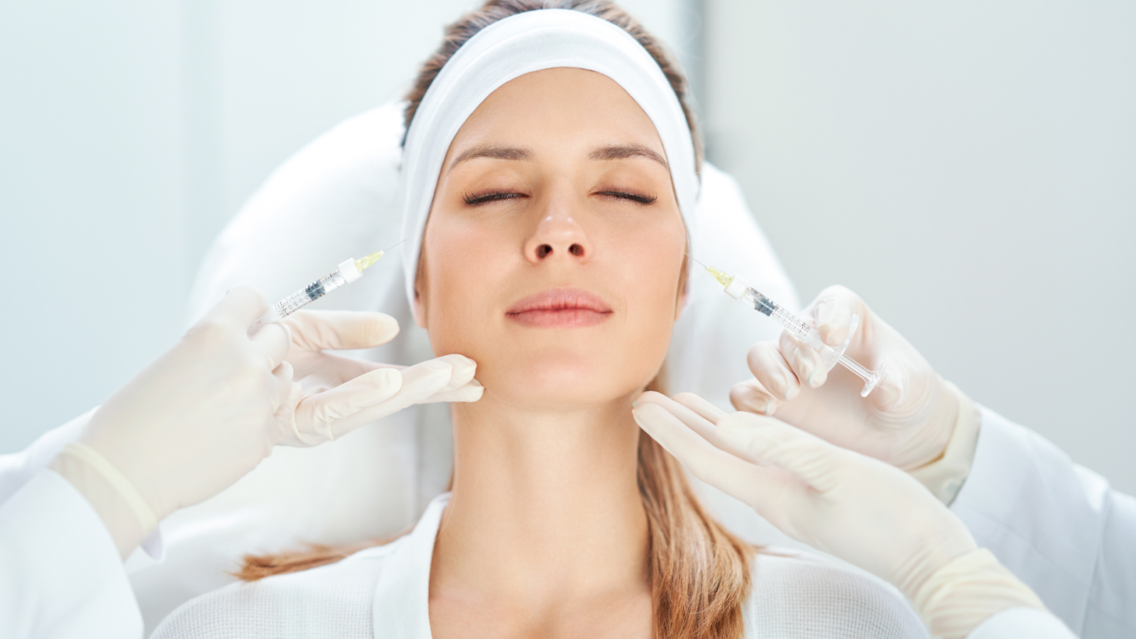 An individual getting Botox injections on multiple facial areas.