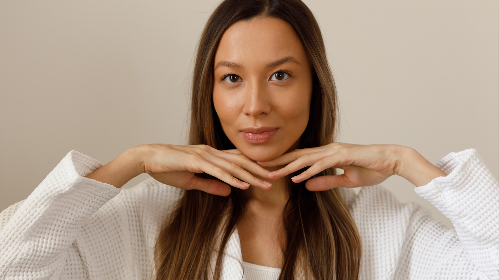 A woman showing off her smooth and clear skin.