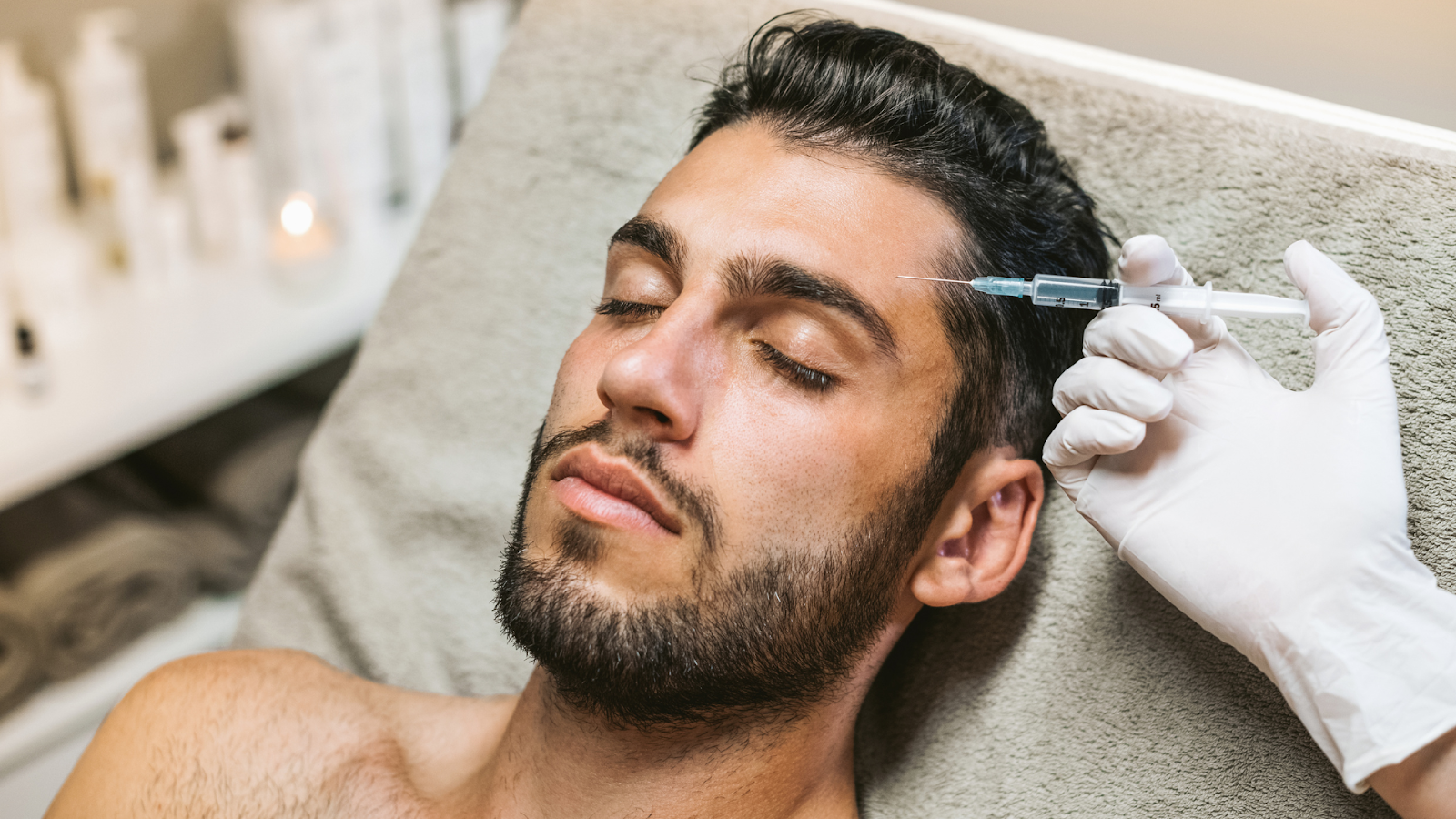 A medical practitioner injecting Botox into a patient's forehead.