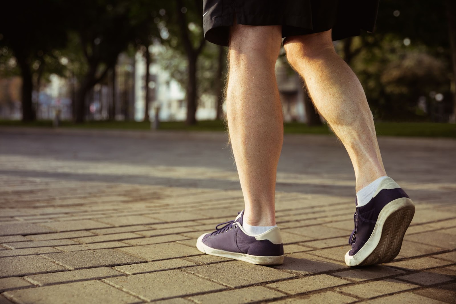 An older individual walking to stay fit.