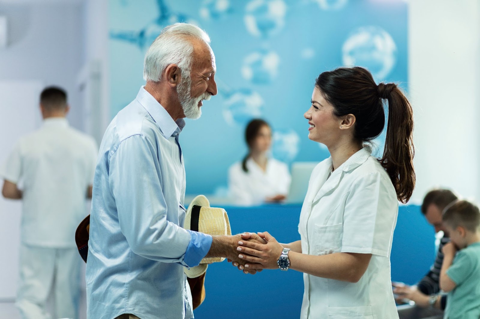 A patient happily handshaking with their doctor.