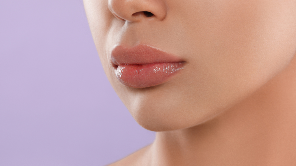 An individual shows their full and plump lips.