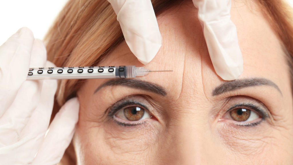 A healthcare professional treating the '11' lines on a patient's forehead.