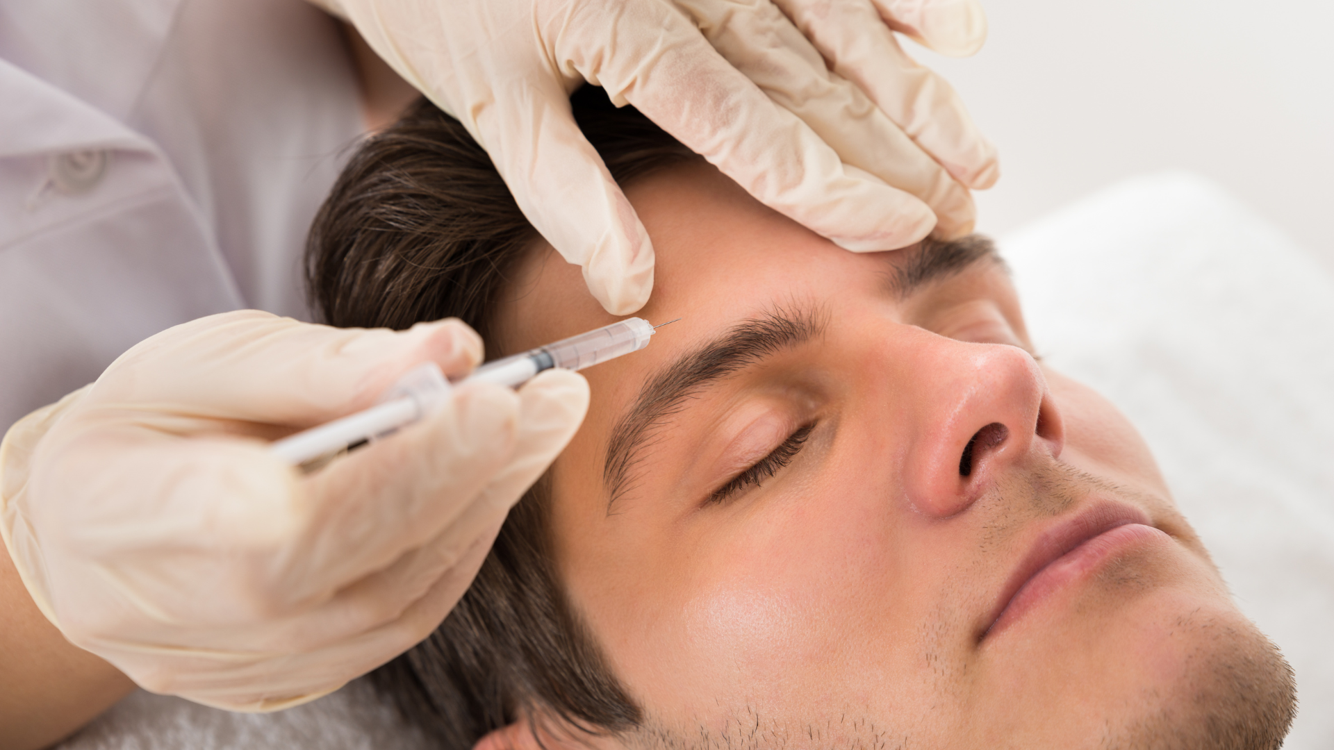 An individual undergoing a Botox treatment near the forehead.