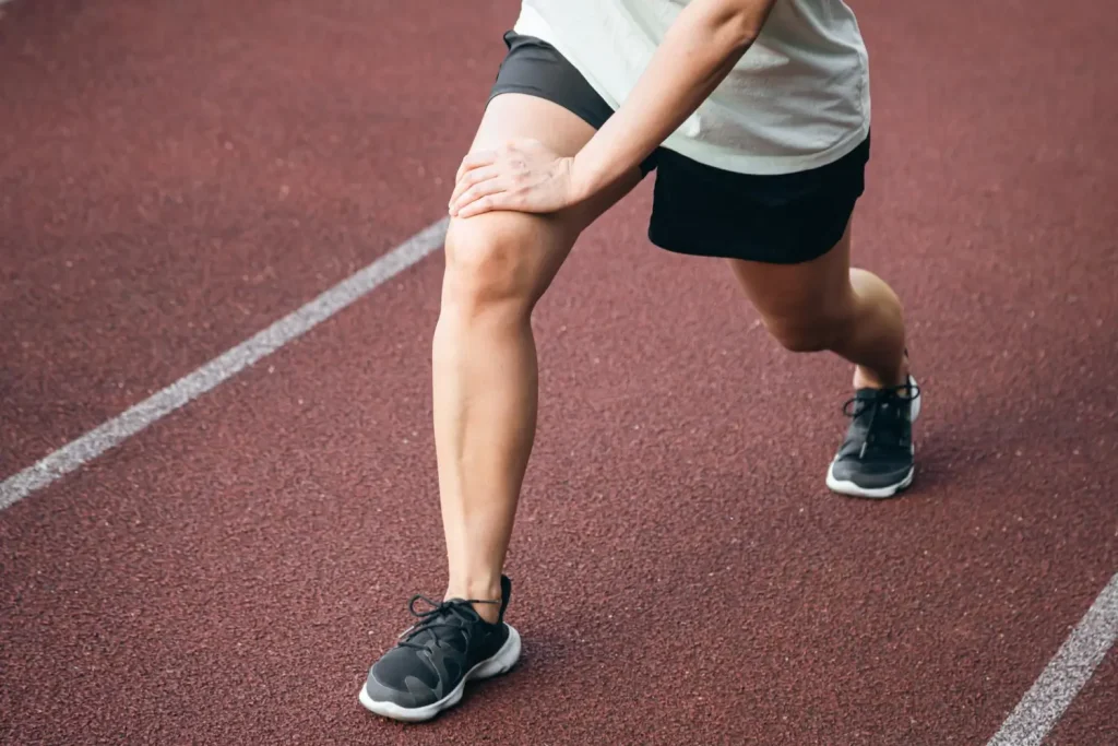 An individual stretching their leg.