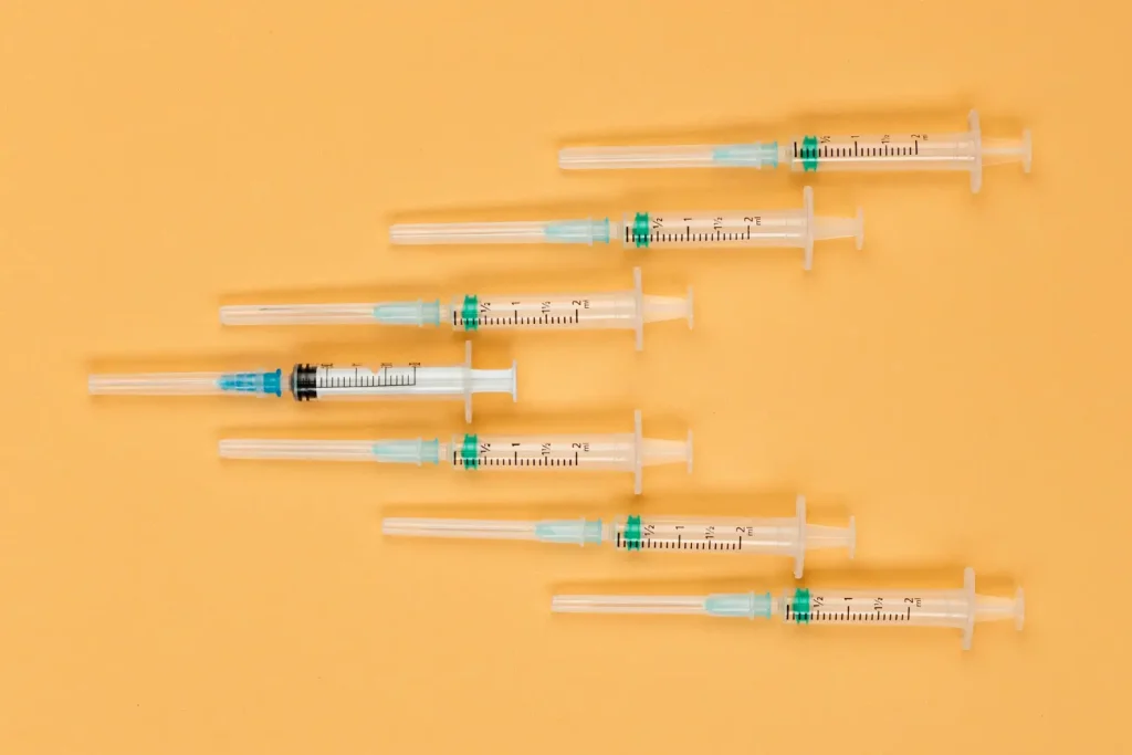 Numerous medical syringes placed together.