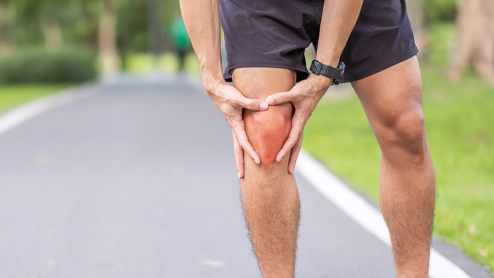 An individual dealing with knee pain while running.