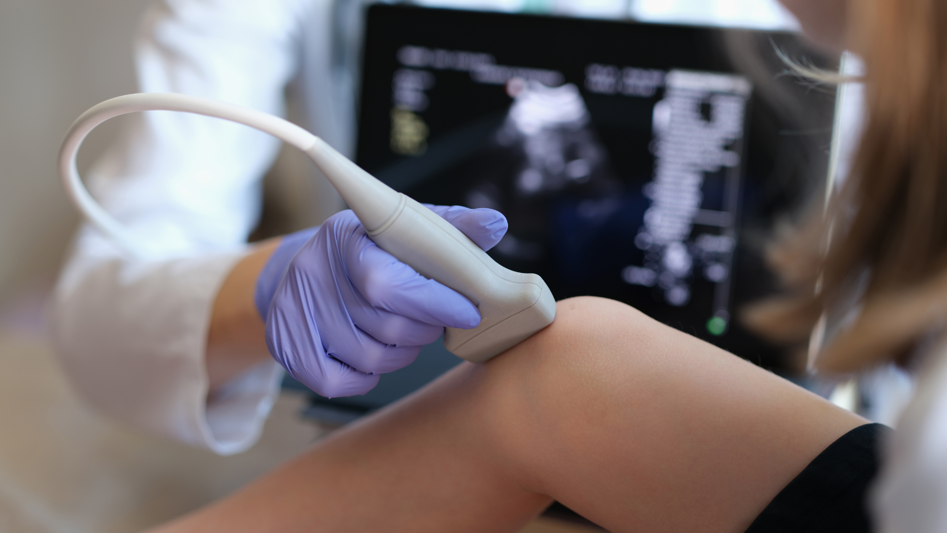 A healthcare provider examining the patient's knee.