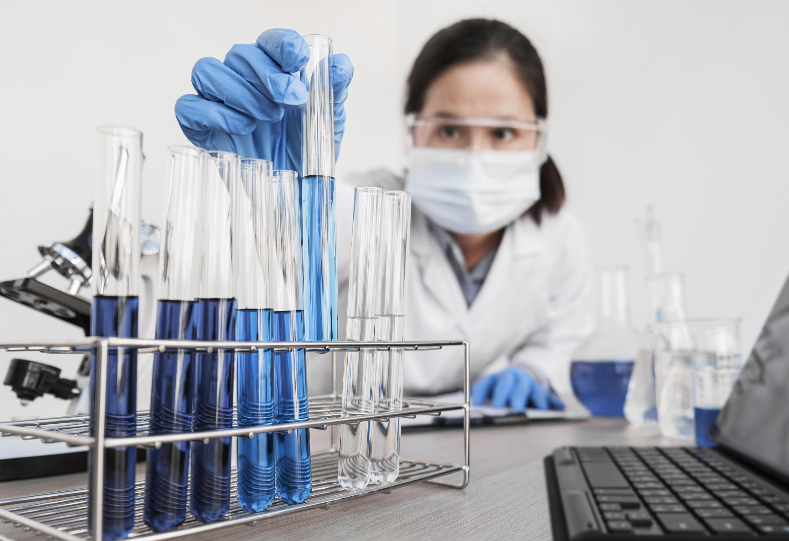 An expert working with chemical substances placed in tubes.