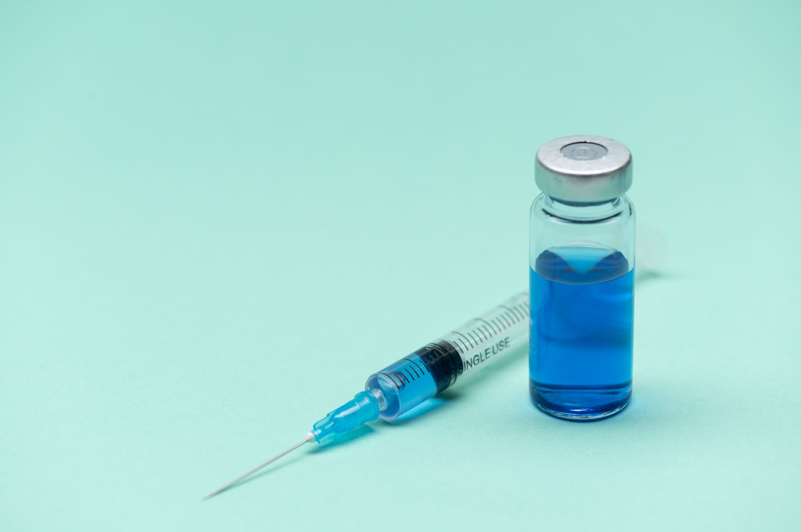 A medical syringe and vial.