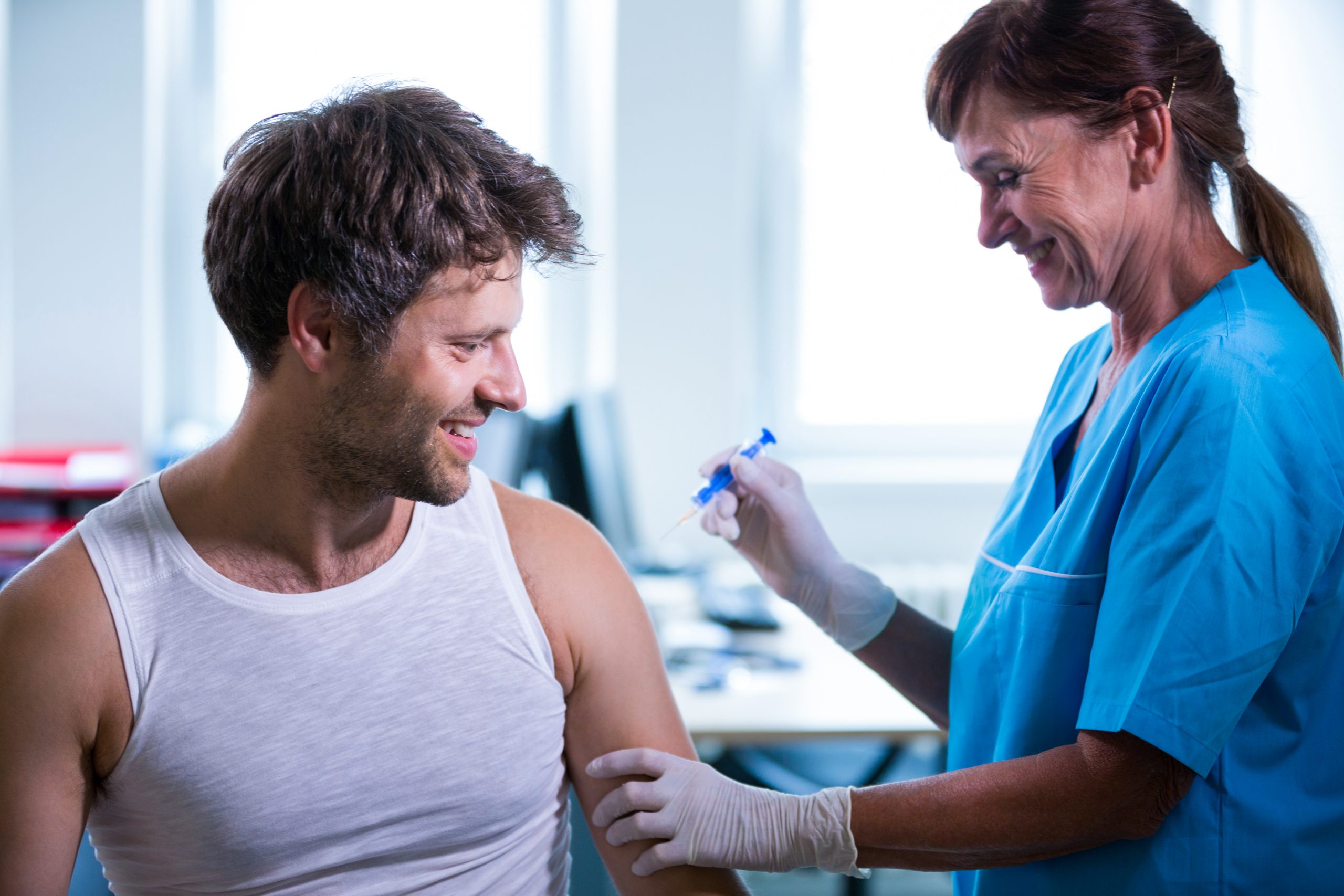 A healthcare provider administering a shoulder injection.