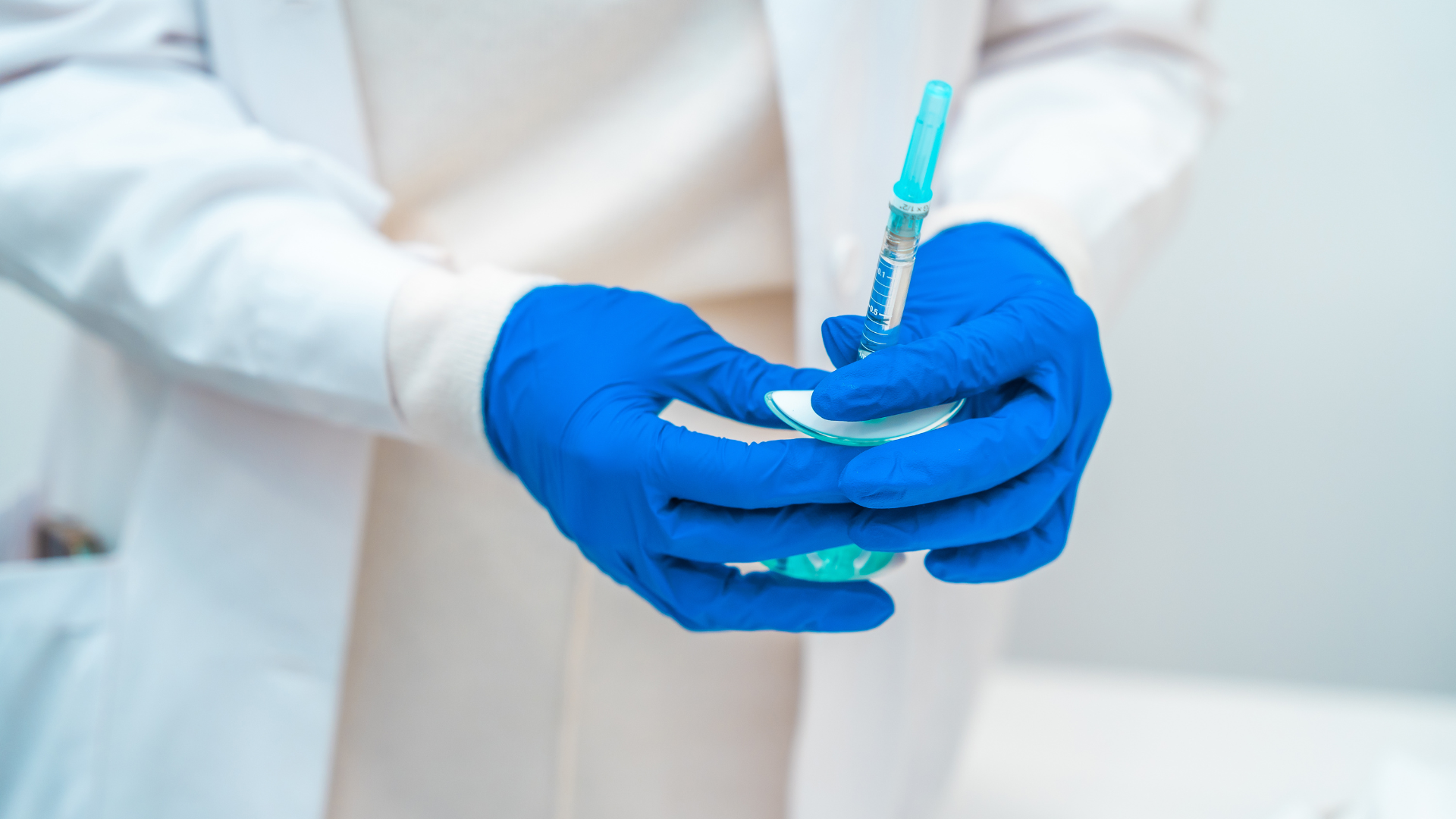 A medical professional preparing an injection for a patient.