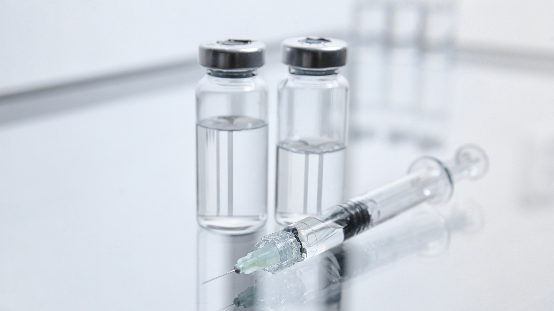 A medical syringe and vials.