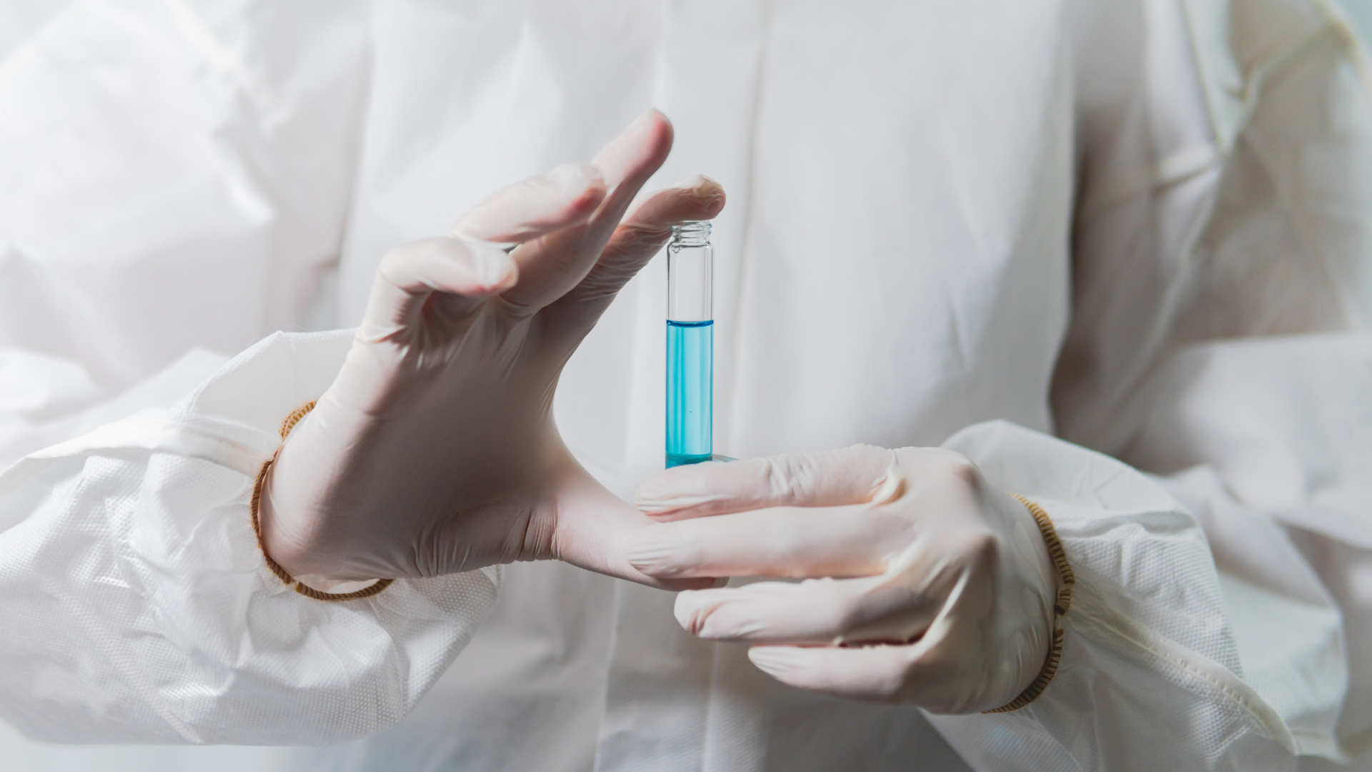 A medical expert holding a vial of a solution.