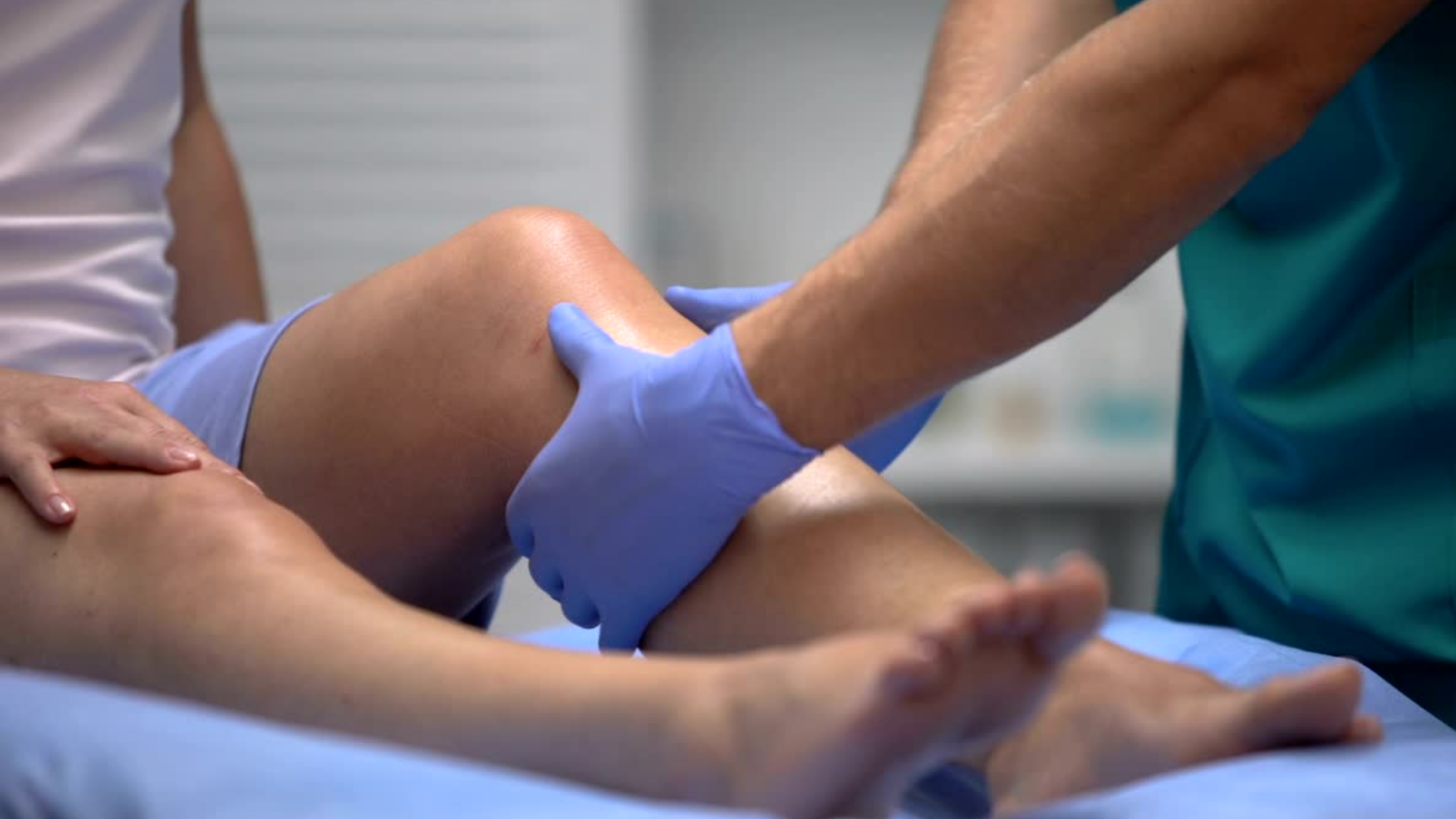 A healthcare provider examining the patient's knee.