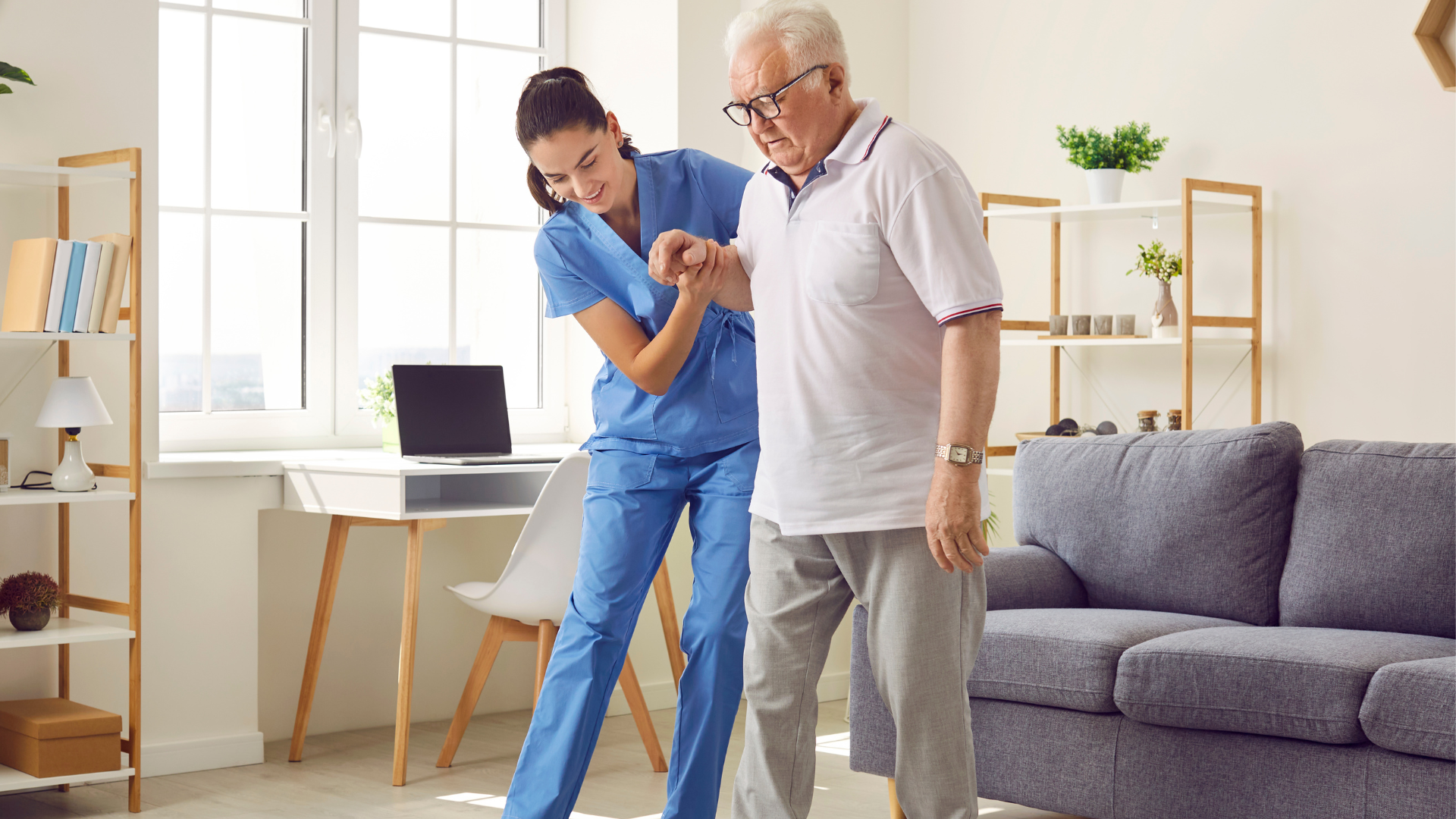 A healthcare provider assisting an older patient while walking.