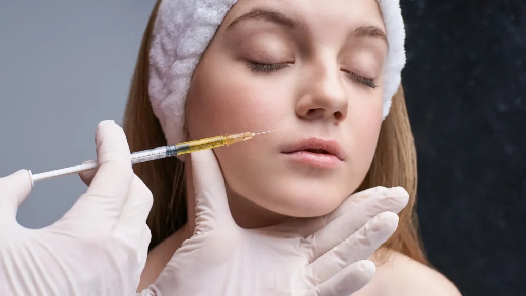 A medical professional administering a facial injection.