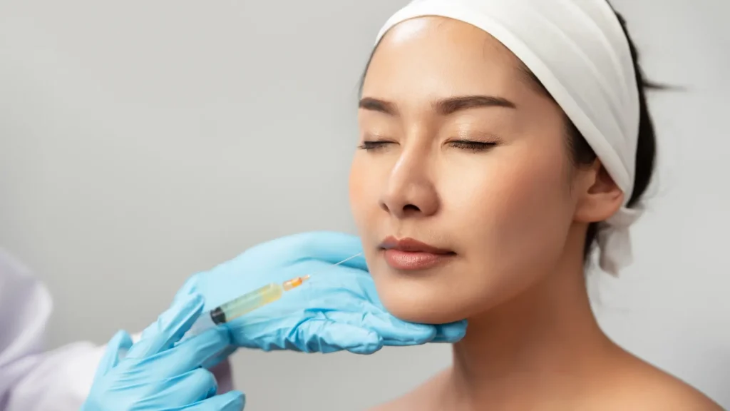 A patient preparing to receive a facial injection.