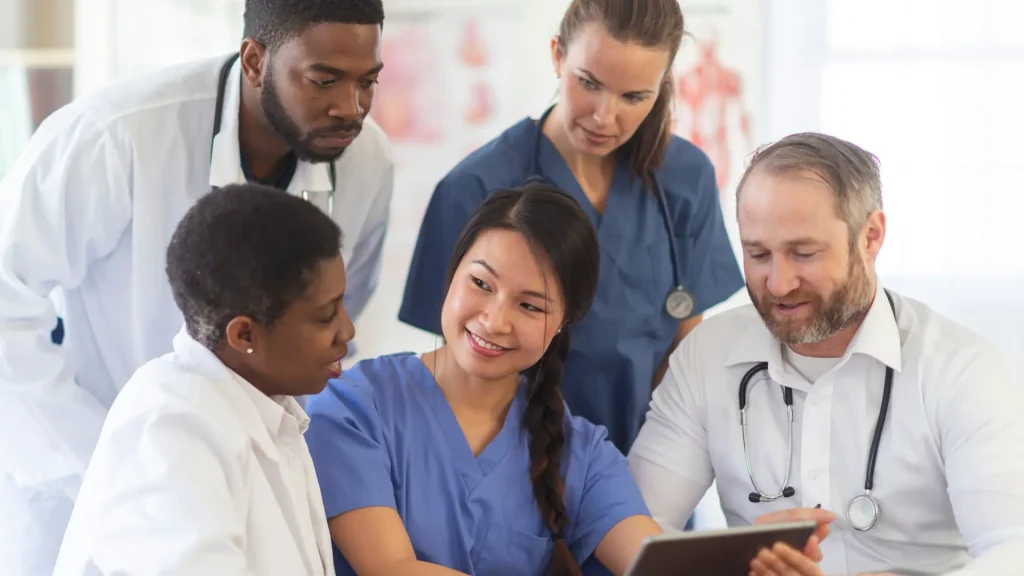 Medical professionals huddled in a discussion.