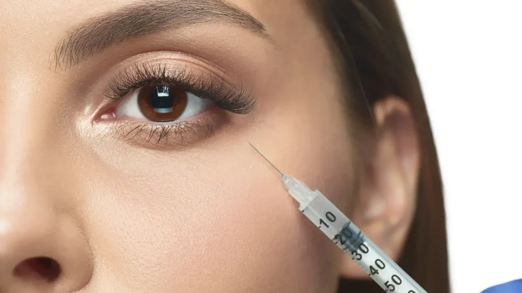 A patient undergoing an injection treatment under the eyes.