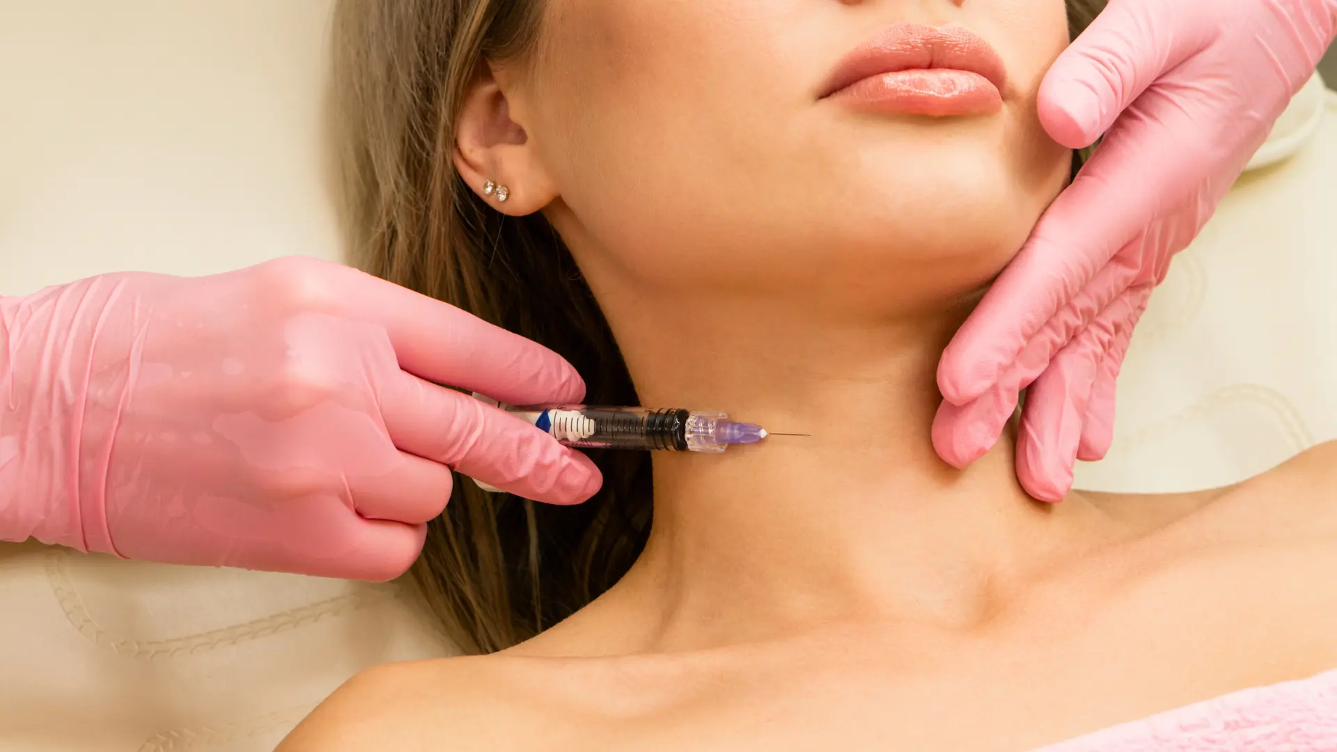 A medical professional administering a neck injection to a patient.