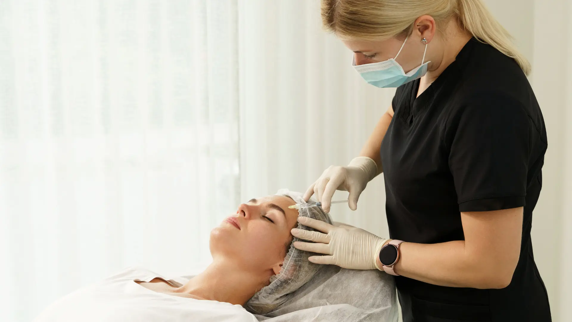 A healthcare provider administering an injectable filler into a patient's forehead.