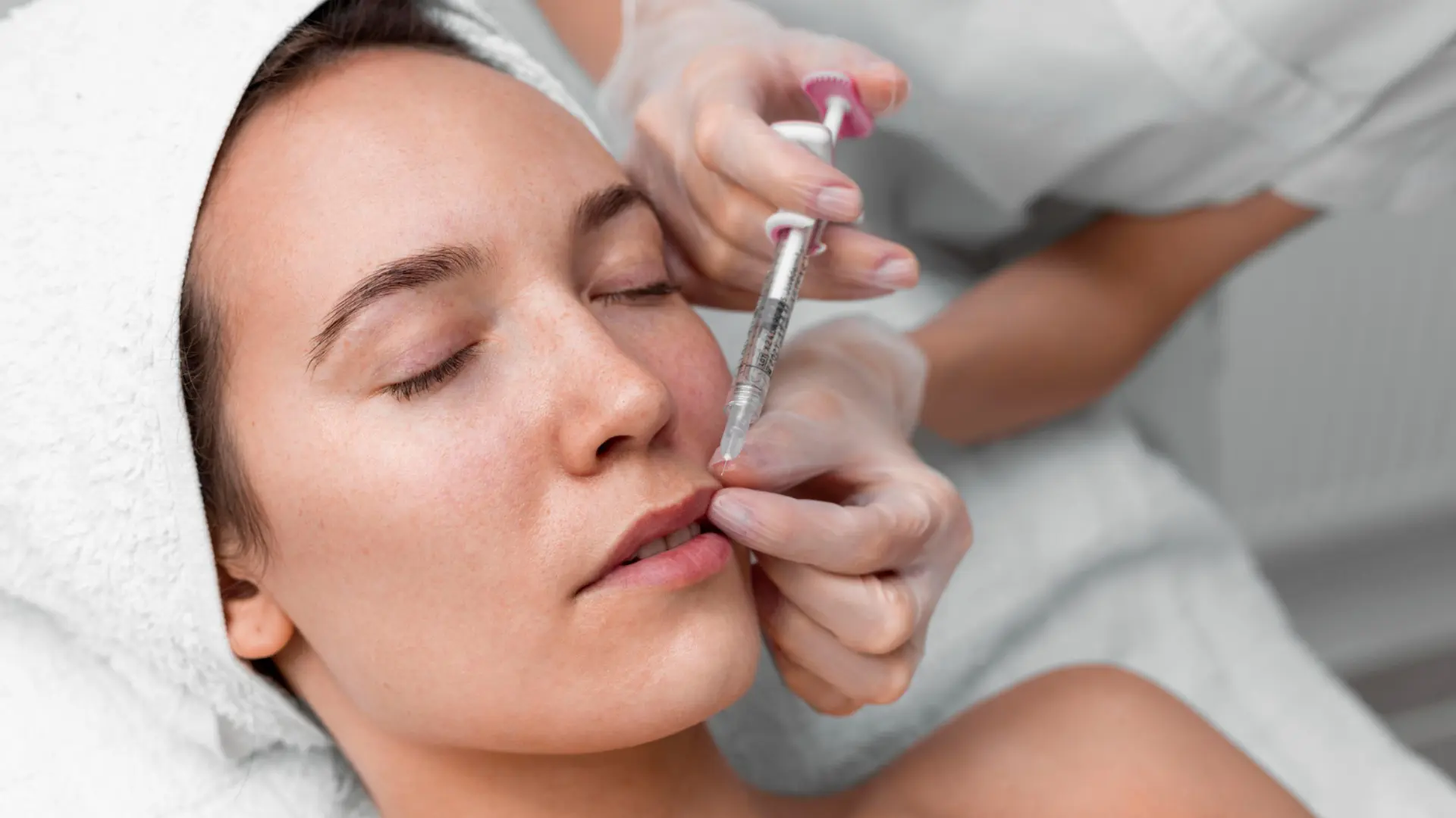 A patient receiving a lip filler injection.