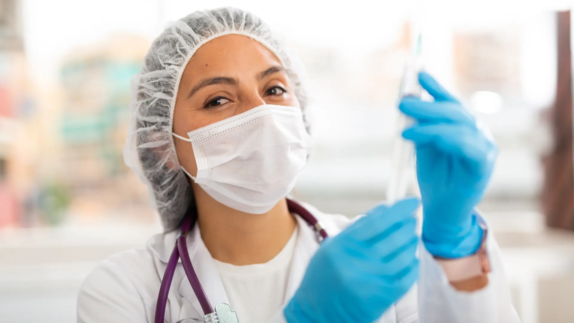 A medical professional preparing a medical syringe for an injection treatment.