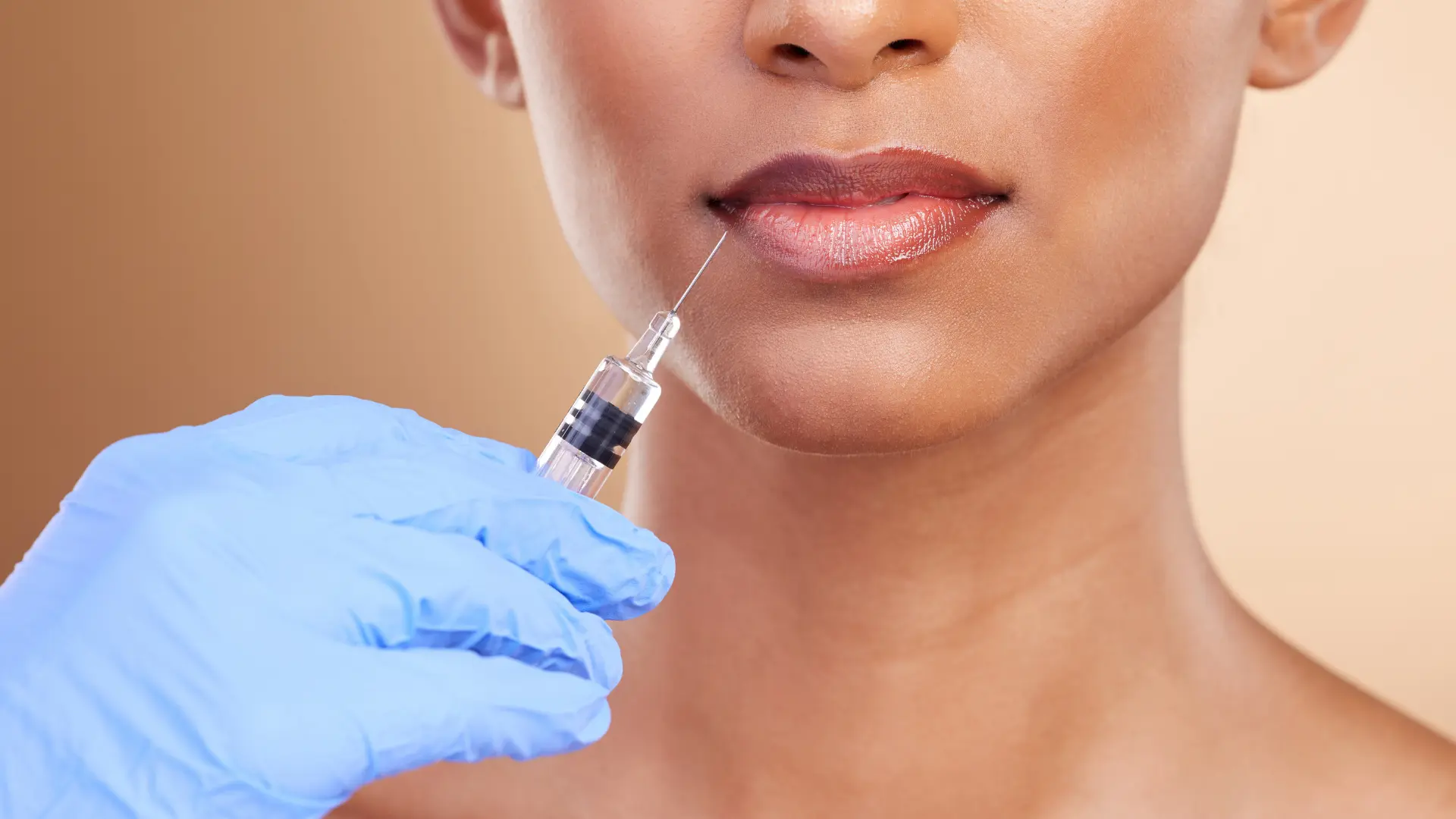 A healthcare provider administering a lip filler injection.