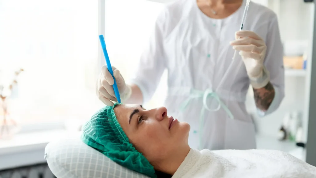 A medical professional marking the injection sites before administering.