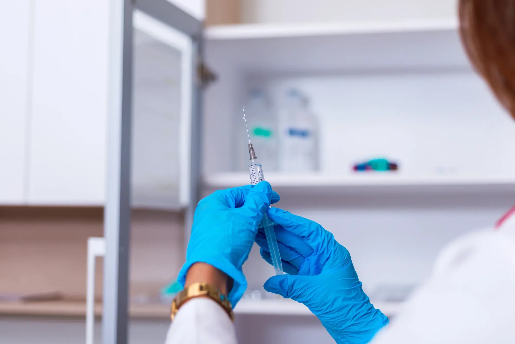 close up on a nurse injector holding syringe