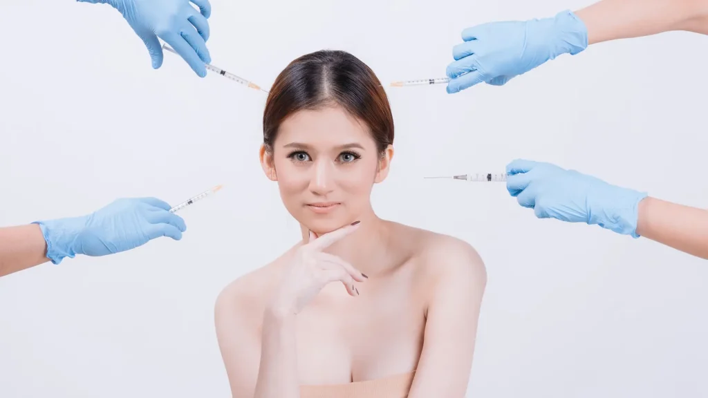 An individual in the middle of various experts holding injections.