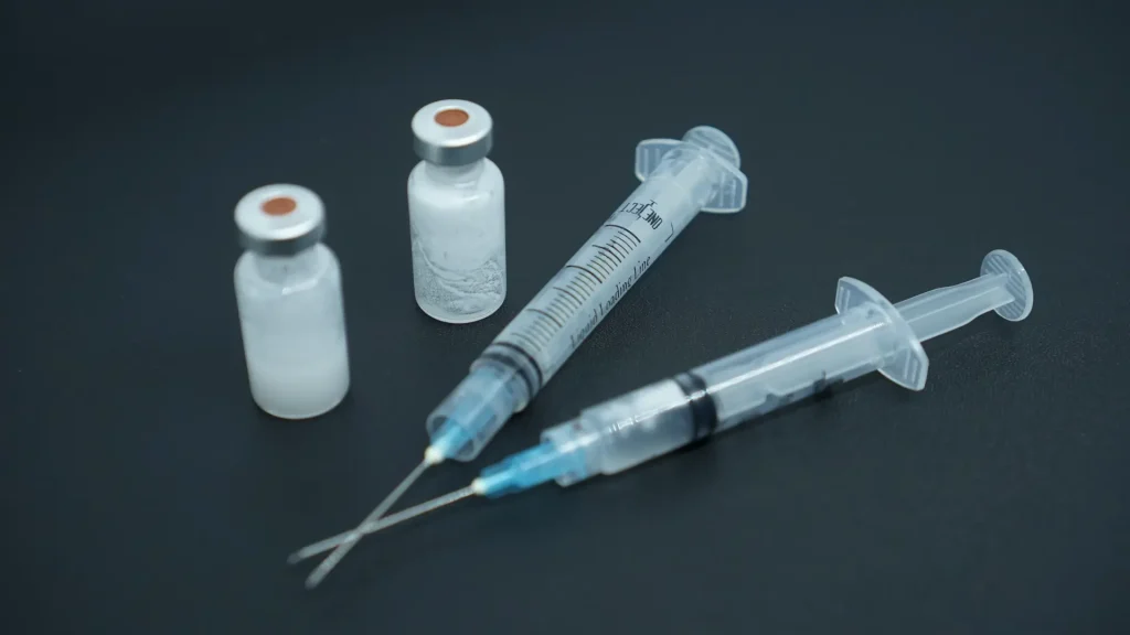 Two medical syringes and vials.