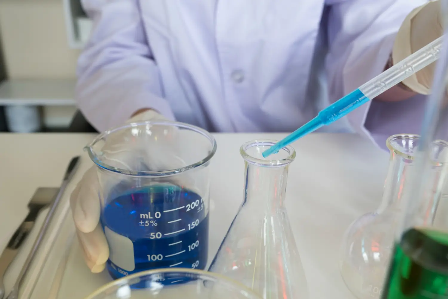 A medical expert in a laboratory creating a formulation.