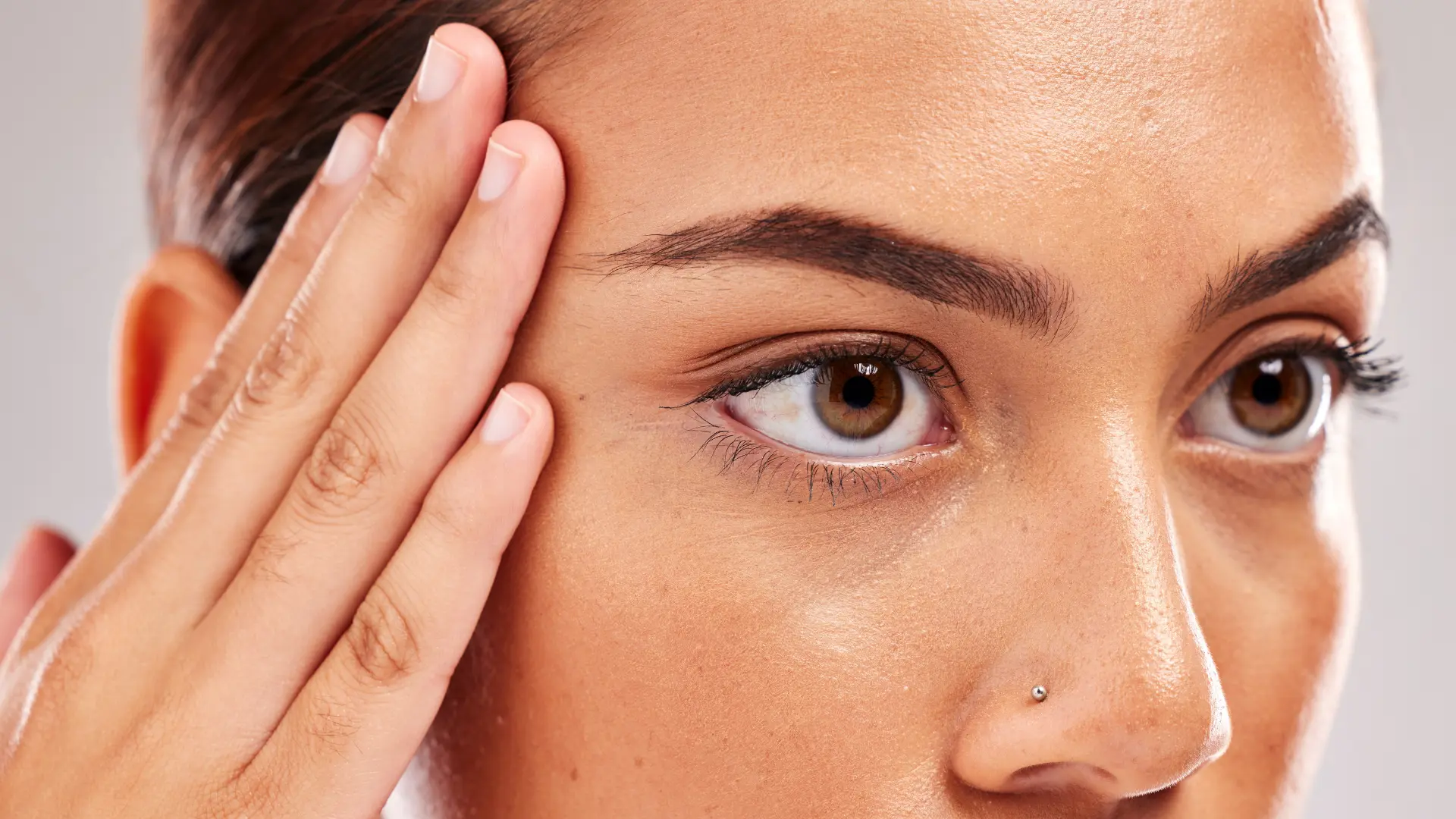 An individual flexing their eyebrow lift.