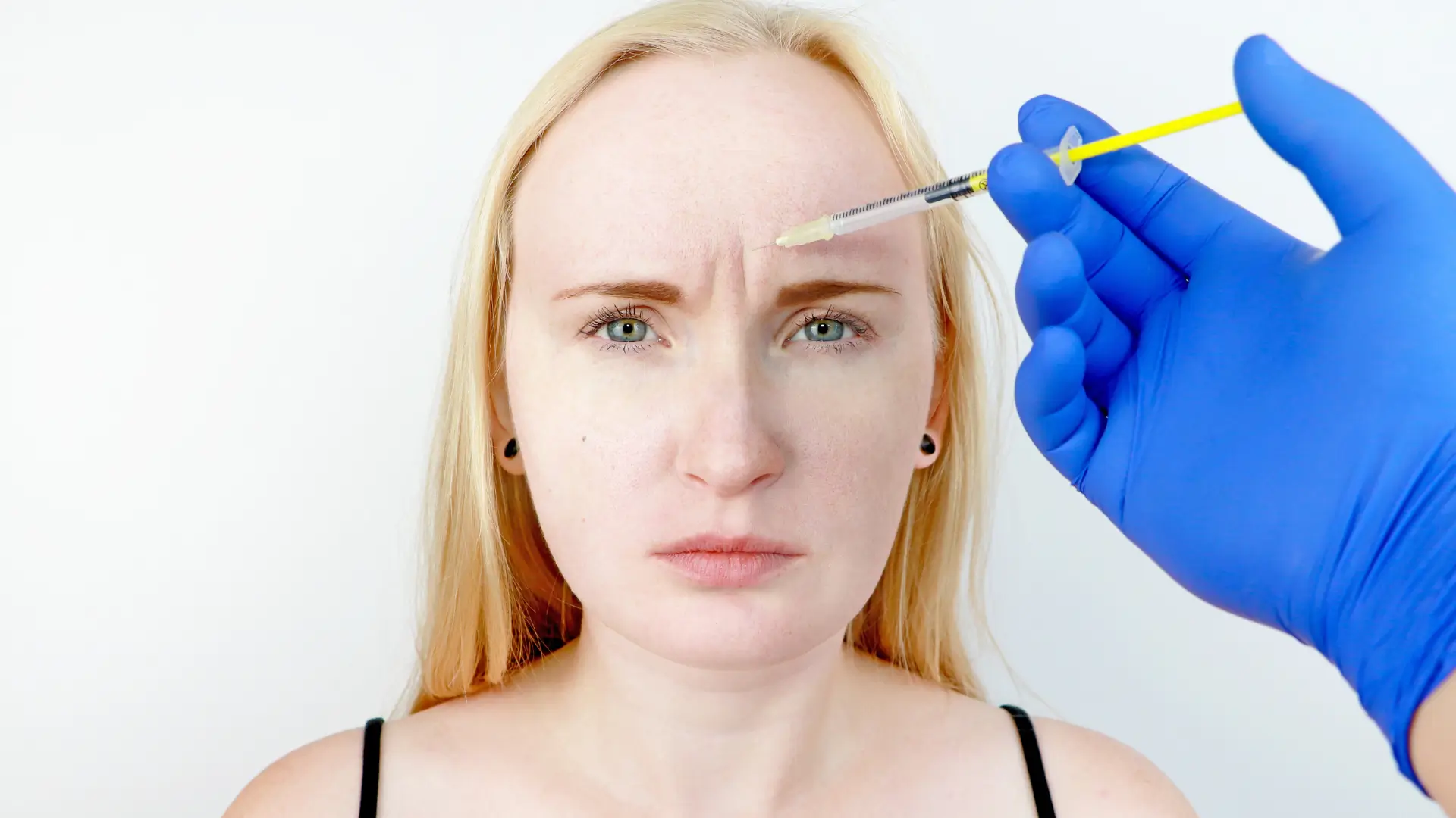 An individual receiving injections for their frown lines.