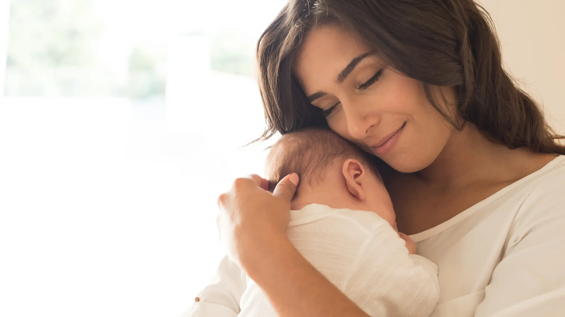 A mother holding her newborn.