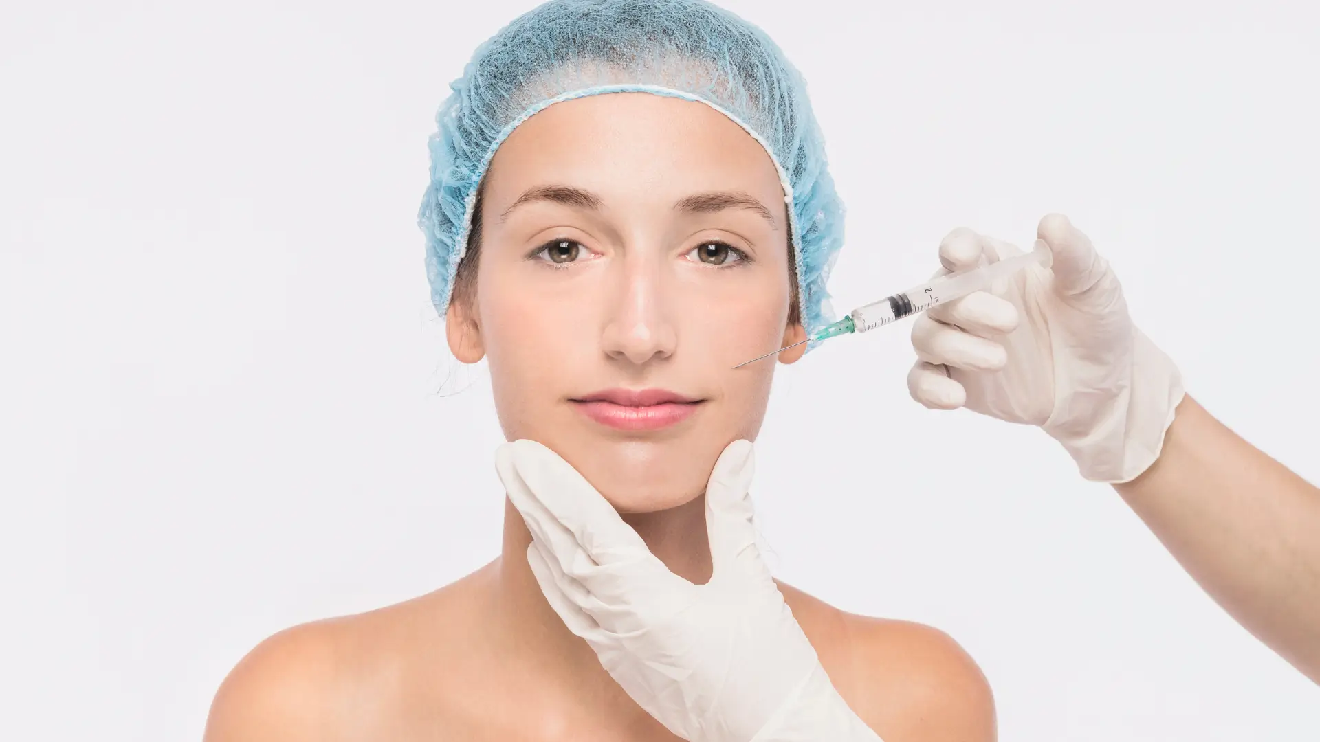 A healthcare provider administering a facial injection to a patient.