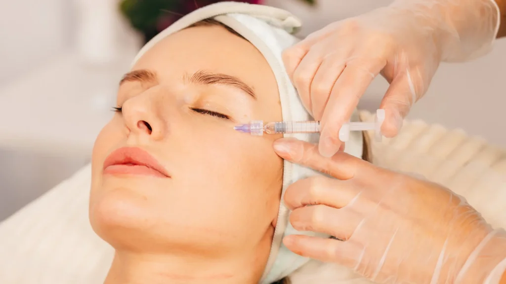 A medical professional administering Sculptra cheekbones injection.