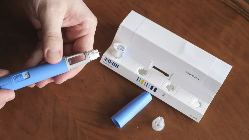 A person preparing the injectable pen before injection.