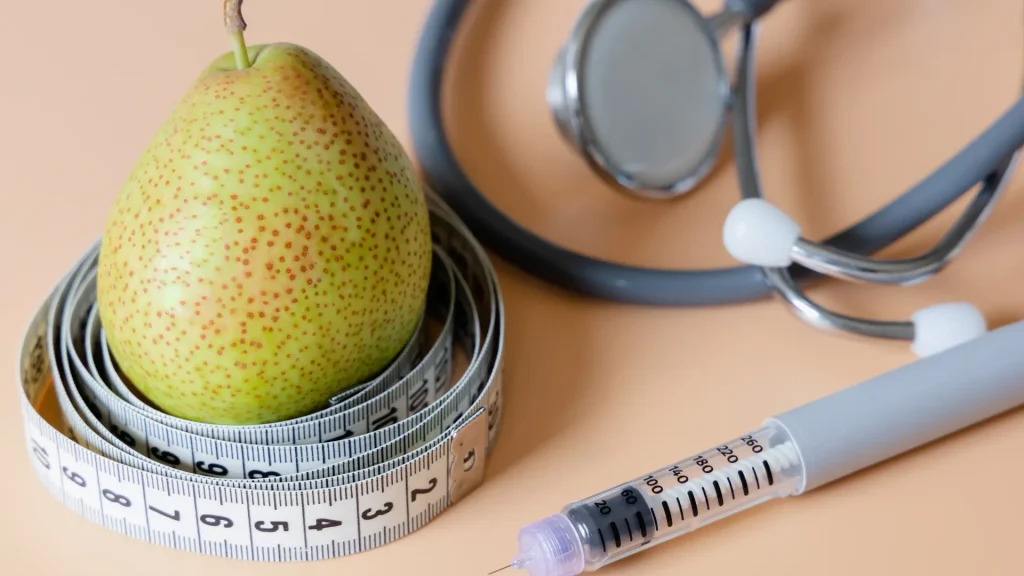 A close-up shot of a prescription injectable for weight loss, healthy food habit, and stethoscope.