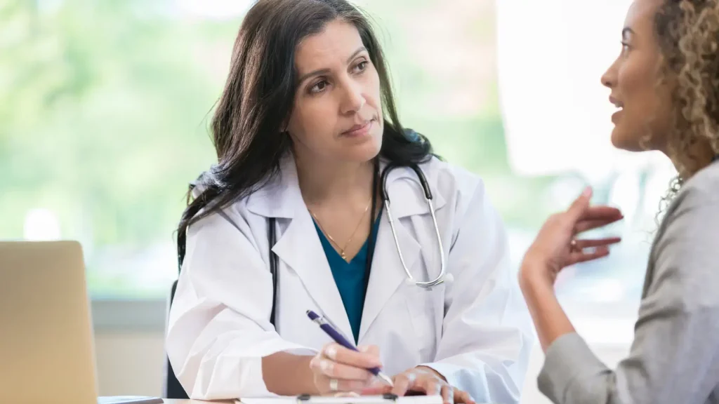 A patient consulting their trusted healthcare provider about their treatment.