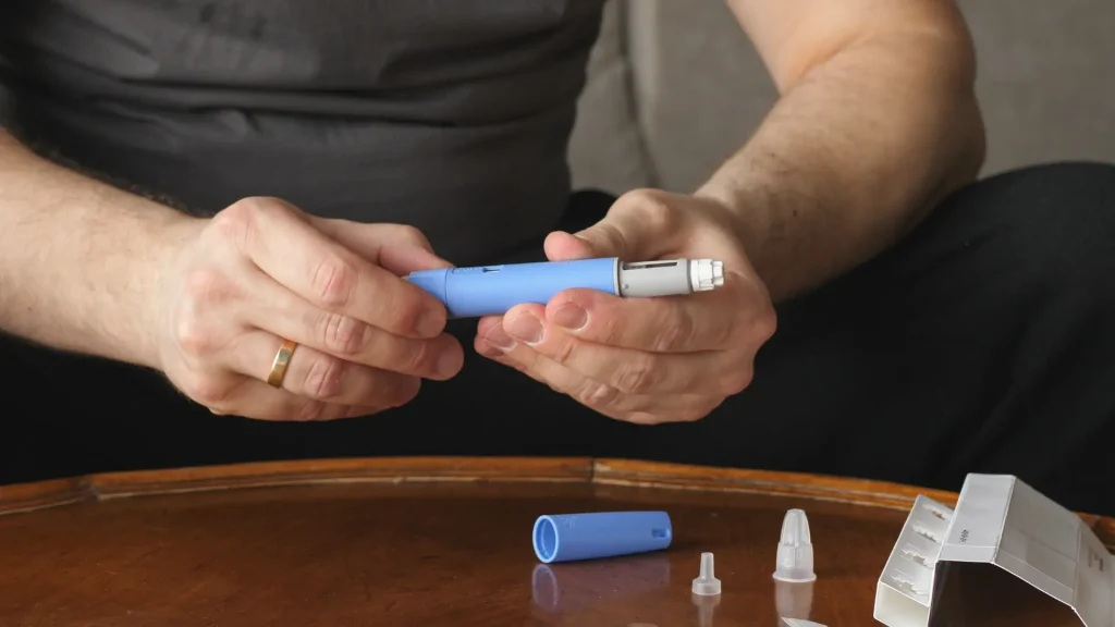 An individual preparing the prescription injectable pen.