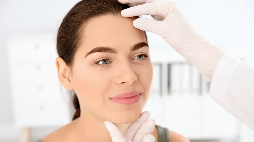 A medical practitioner examining the patient's facial features.